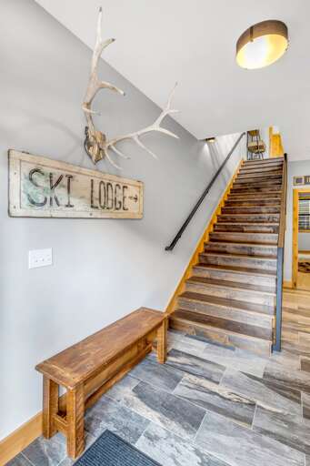 Stairway up to the mail floor. Hallway to the right of the stairs leads to the lavish bunk room