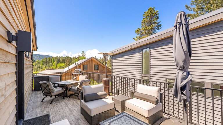 The large balcony features dining area, a state of the art pizza oven, propane heaters, as well as a luxury seating area to relax after a long day of outdoor activities.