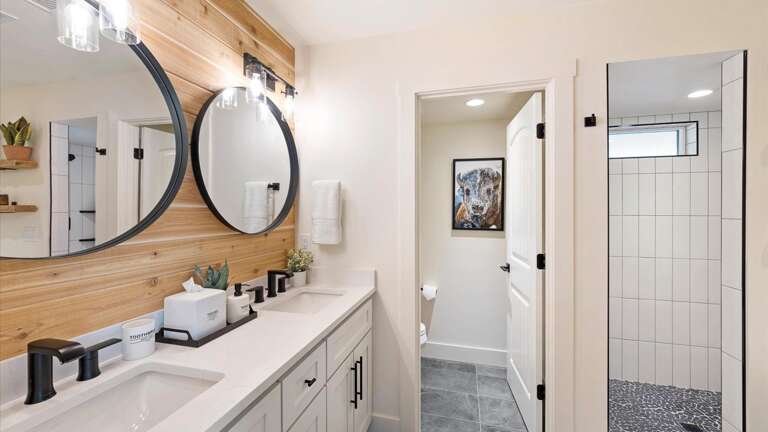 The master ensuite bathroom feagtures a double vanity, large soaking tub, walk-in shower, and private toilet room.