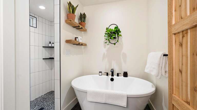 The master ensuite bathroom feagtures a double vanity, large soaking tub, walk-in shower, and private toilet room.