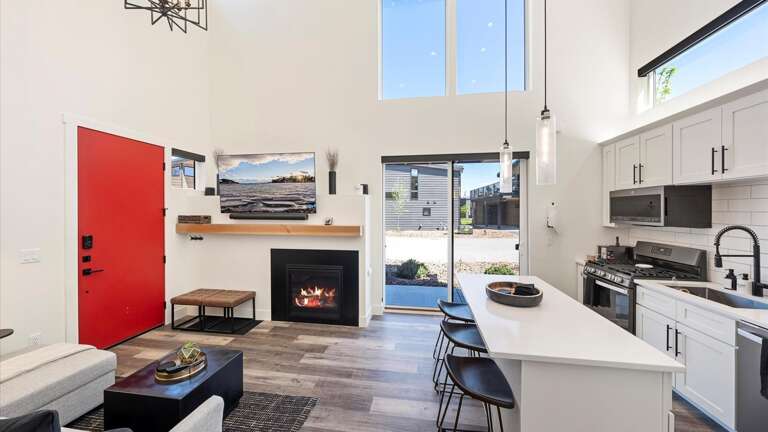 The open concept living room and kitchen with a walkout patio.
