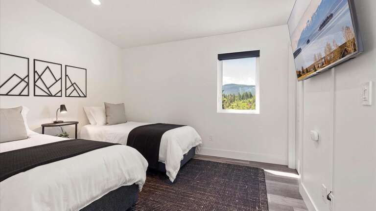 The upstiars bedroom features two twin xl beds with luxury linens and state of the art mattresses, HDTV with streaming capabilities, ensuite bathroom, and walk-in closet.
