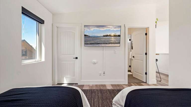 The upstiars bedroom features two twin xl beds with luxury linens and state of the art mattresses, HDTV with streaming capabilities, ensuite bathroom, and walk-in closet.