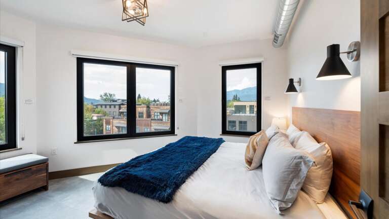 Junior master bedroom with king bed, custom closet, smartTV, and alpine views.
