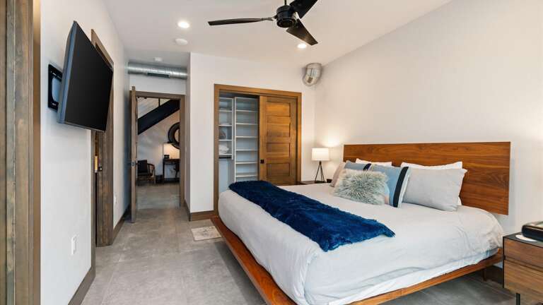 Master suite with king bed, custom closet, ensuite bathroom, smartTV, and walk out balcony