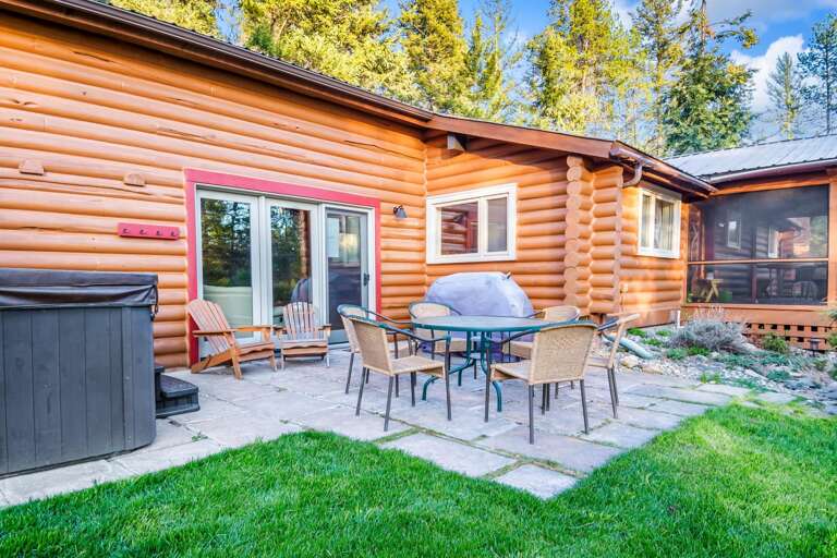 The grand patio with BBQ grill (propane provided), luxury hot tub, and outdoor dining seating for 6.