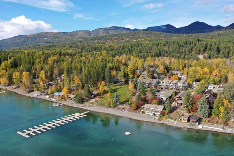 Aerial view of the Mountain Harbor private beach on Whitefish Lake with dock. (Boat slips available with reservation).