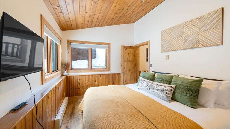 Junior master bedroom with alpine views, large closet, luxury linens, HDTV with streaming capabilities