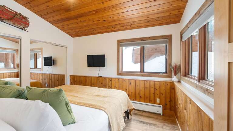 Junior master bedroom with alpine views, large closet, luxury linens, HDTV with streaming capabilities