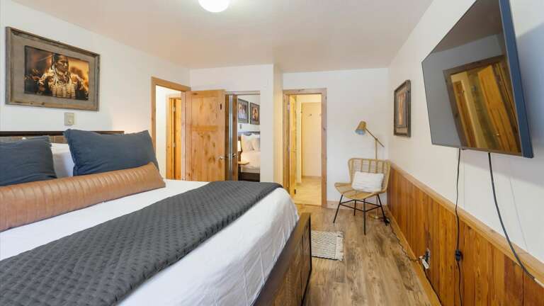 Master bedroom with HDTV with streaming capabilities, luxury linens, closet, seating area and ensuite bathroom