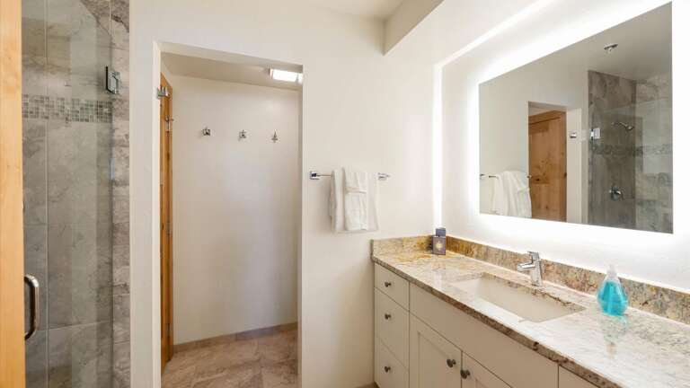Master ensuite bathroom with shower, vanity, and toilet area.