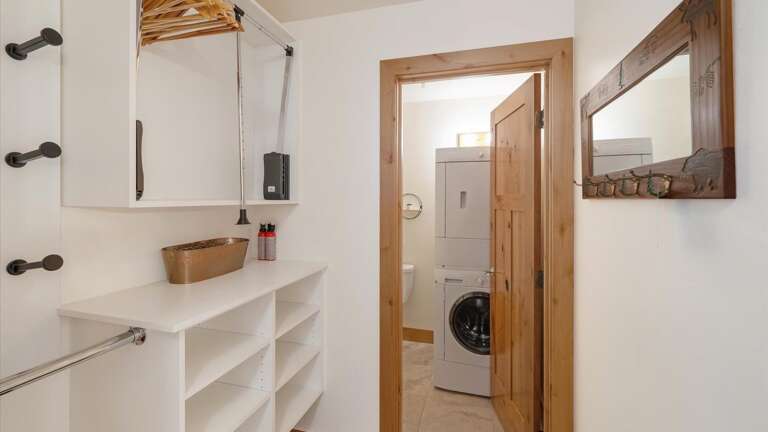 Mudroom/entry area with lots of ski storage and half bathroom with stackable washer