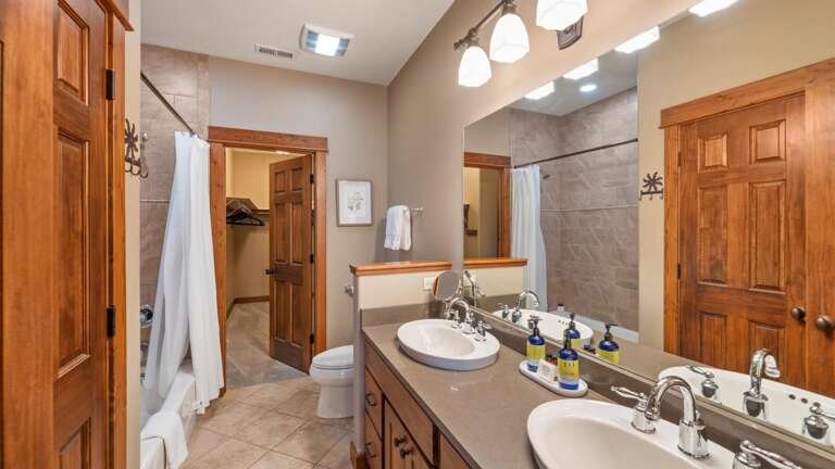 The master ensuite bathroom features a double vanity, shower/tub combination, toilet, and walk-in closet.