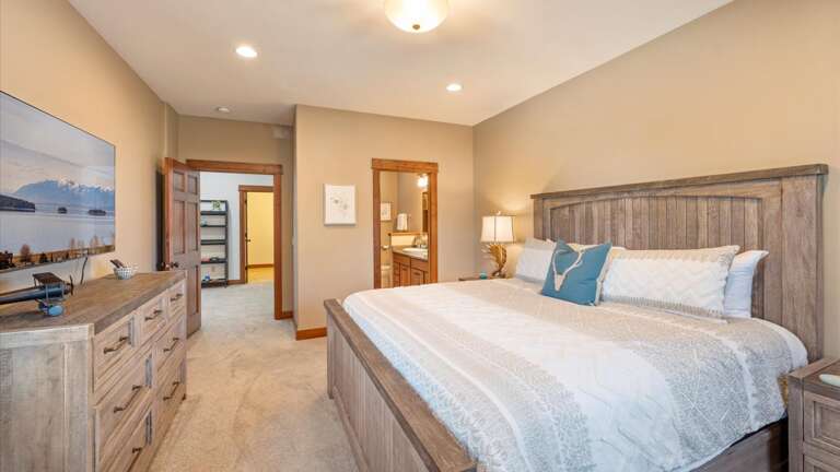 The master suite features a luxury king mattress and linens, dresser, HDTV with streaming, ensuite bathroom and large walk-in closet.