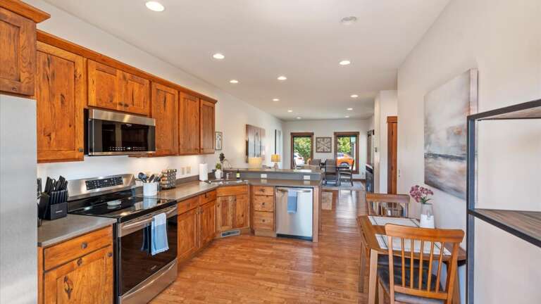 The open concept kitchen features breakfast bar seating for 3 and a fully stocked kichen with all the amenitiies to make the meal of your dreams!