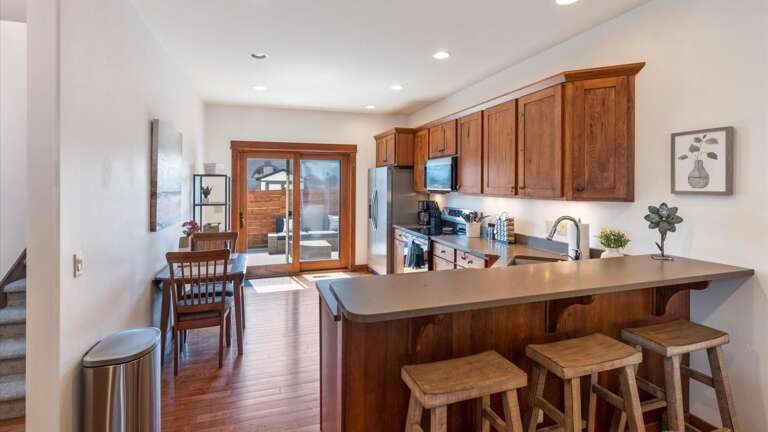 The open concept kitchen features breakfast bar seating for 3 and a fully stocked kichen with all the amenitiies to make the meal of your dreams!