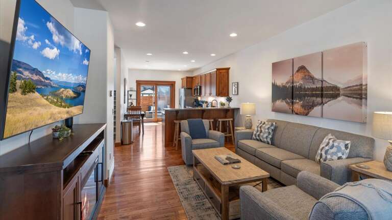 The open concept living room, dining area, and kitchen provide guests with a cozy environment after a day of adventures!