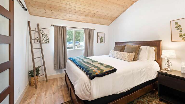 Guest bedroom #1 features a luxury queen mattress, vaulted ceilings, and ample closet space.
