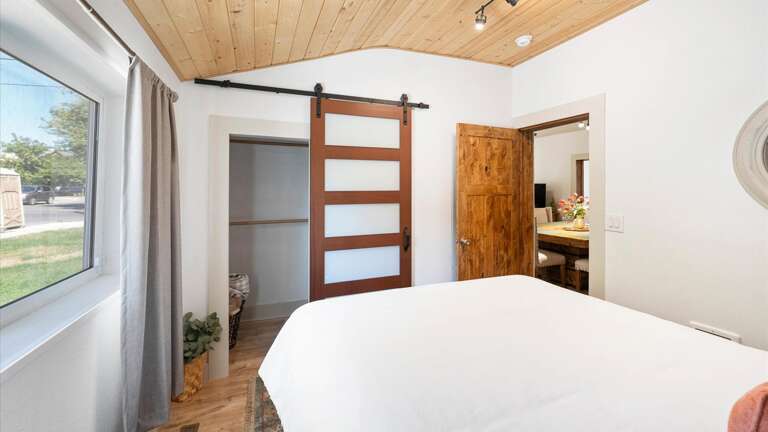 Guest bedroom #2 features a luxury queen mattress, vaulted ceilings, and ample closet space.