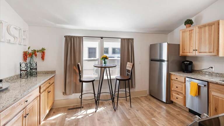 The large kitchen is fully stocked with cookware and top of the line appliances. The kitchen also features a cozy coffee nook with seating for two.