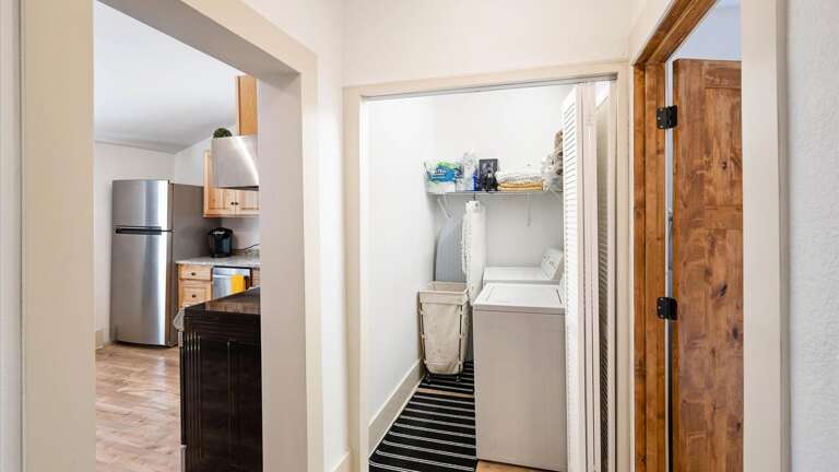 The laundry room features a washer and dryer and lots of storage!