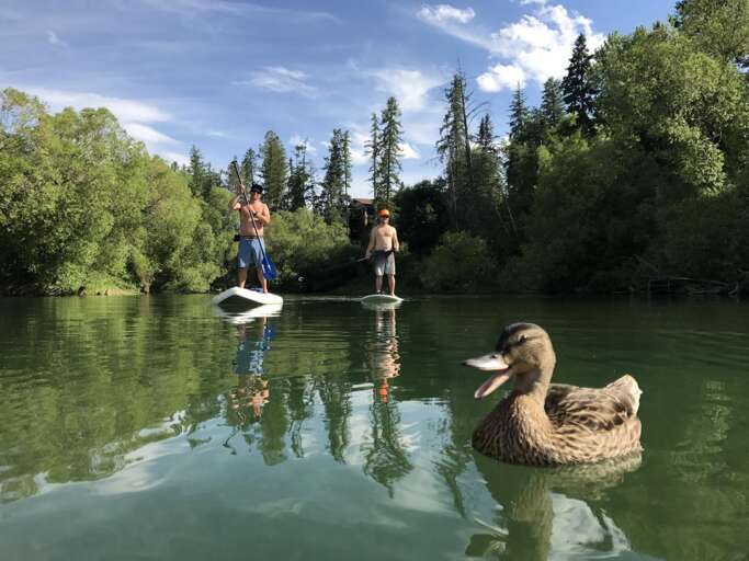 Stand Up Paddle Boarding on the Whitefish River, less than a block away from the property to a dock to get on the river.