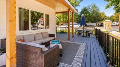 Wrap around porch with seating and dining area.