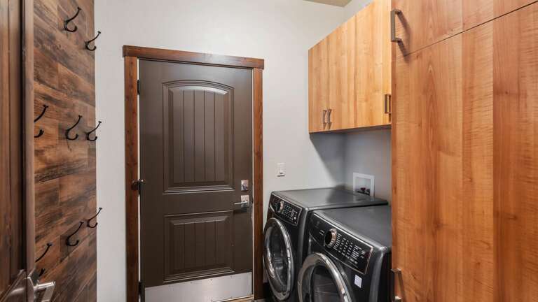 Main floor mudroom and laundry room off the garage. The perfect space to hang hats and gloves and helmets after a long day on the slopes!