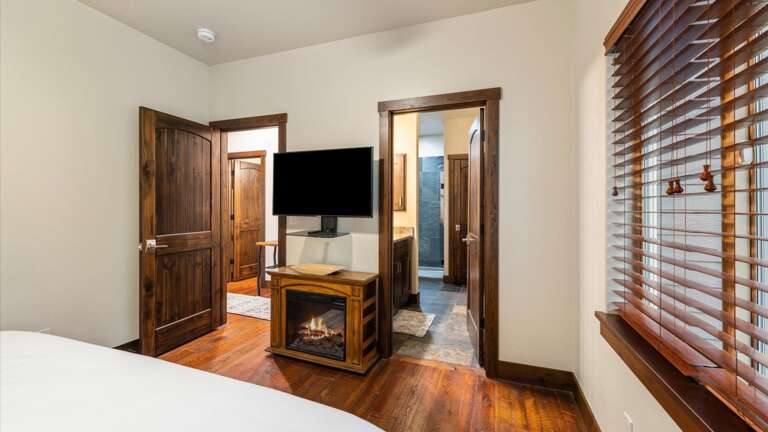 Master bedroom with luxury king mattress, electric fireplace, ensuite bathroom, HDTV with streaming capabilities, walk-in closet.