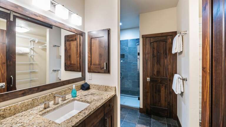 Master ensuite bathroom with large vanity, walk-in shower, and toilet
