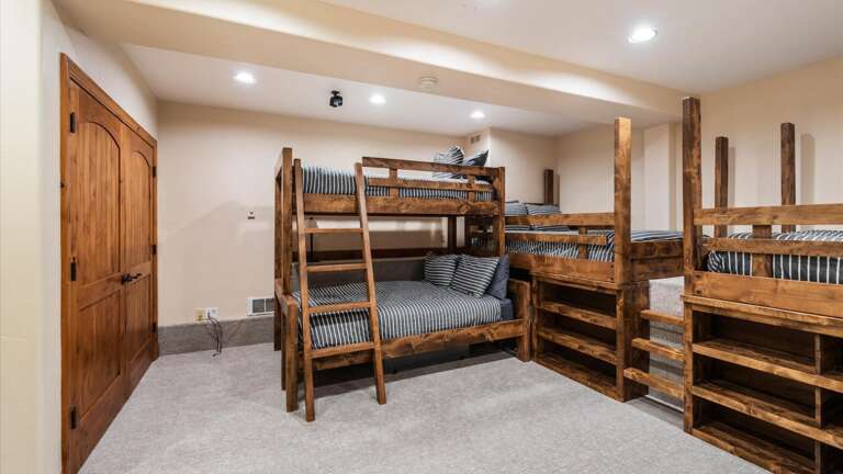 Bunk room #1 with 3 full size beds, 1 twin bed, tons of storage, and HDTV with streaming capabilities.