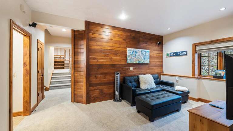 Lower level common area with gas stove, flat screen TV with streaming capabilities