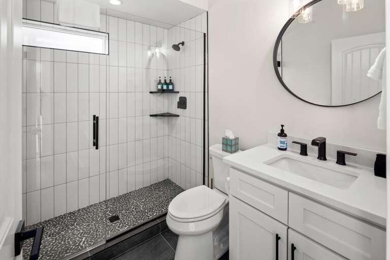Guest bedroom ensuite bathroom with vanity, toilet, and luxury shower.