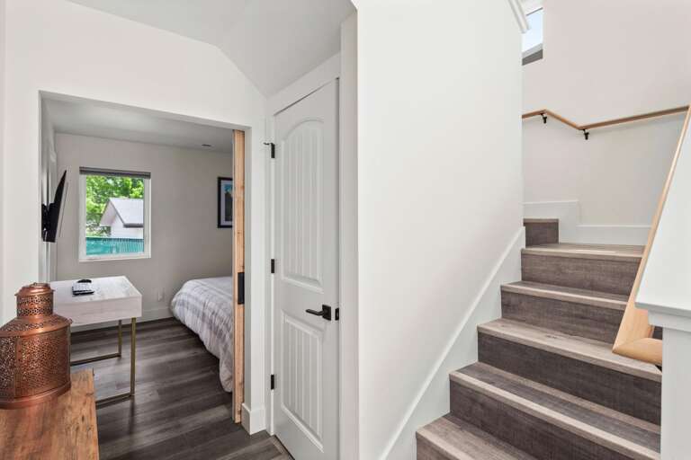 Head up to the stairs to the office area, guest bedroom and top floor balcony.