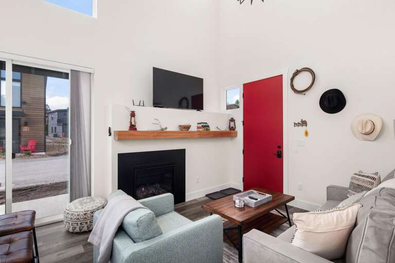 The living room features a luxury memory foam queen size pullout, large HDTV with streaming capabilities, gas fireplace, and vaulted ceilings.