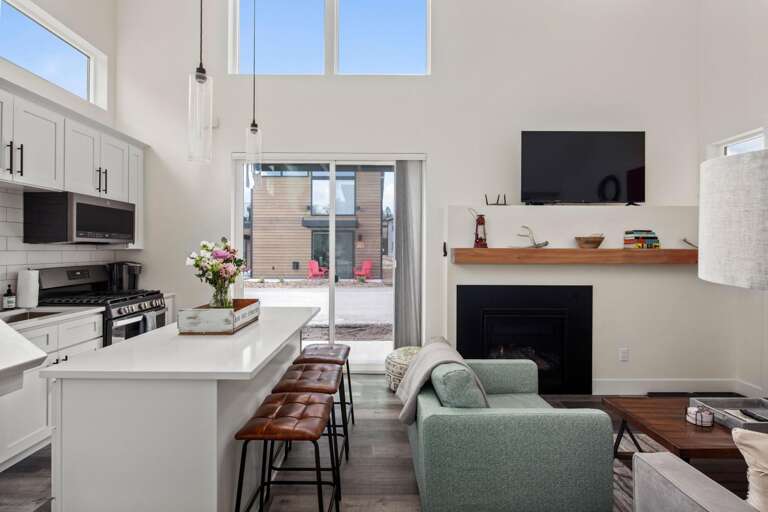 Main living space with open concept living room and kitchen and walkout to a patio.