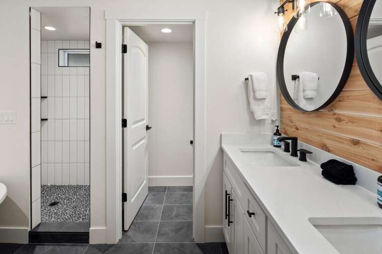 Master ensuite bathroom with double vanity, luxury soaking tub, large shower, and private toilet.