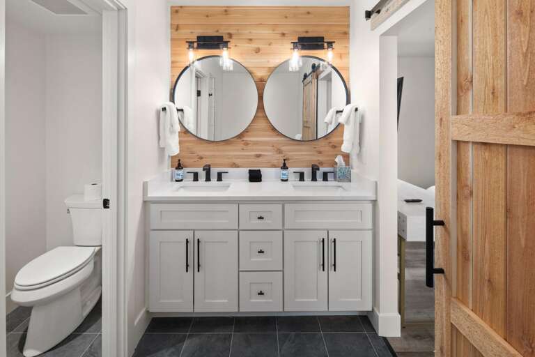 Master ensuite bathroom with double vanity, luxury soaking tub, large shower, and private toilet.