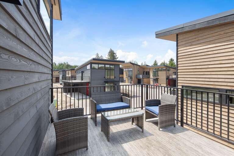 Rooftop balcony with dining area, gas grill (propane provided), and seating area with views of Big Mountain (Whitefish Mountain Resort).