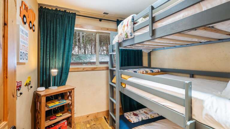 The bunk room features 3 twin beds.