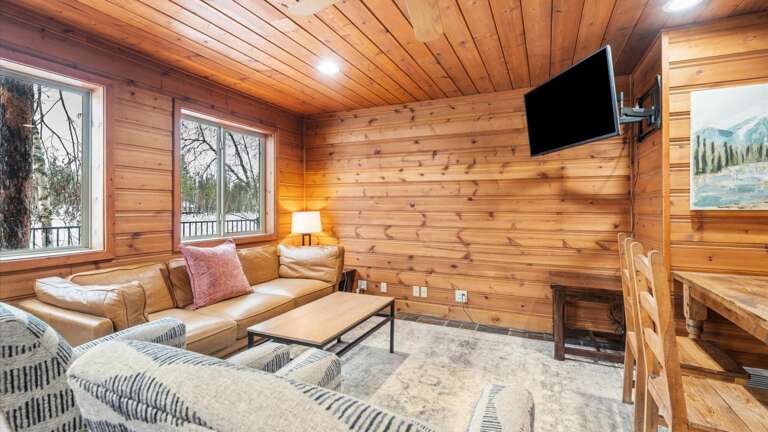 Living room with HDTV with streaming capabilities, wood burning stove, cozy seating,