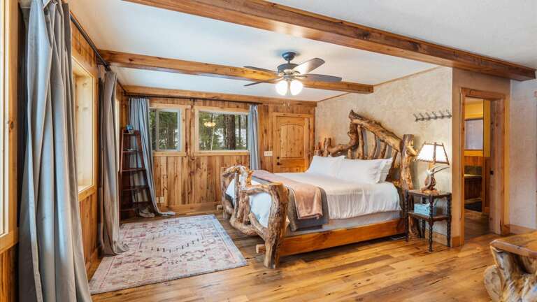 The upstairs master suite features lake views from the comfort of this California King bed, a walk-in closet,