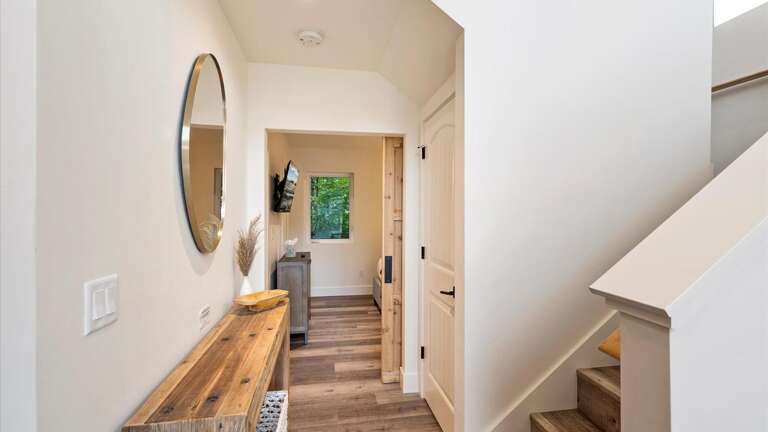 Hallway to the master bedroom and up to the second floor.