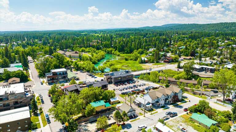 Aerial view of the property featuring the close proximity to the Whitefish River and downtown Whitefish.