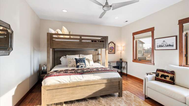 The bunk room features a king bed on the bottom bunk, twin XL bed on the top bunk, a queen sofa sleeper, desk area, walk-in closet, and a HDTV with streaming capabilities.