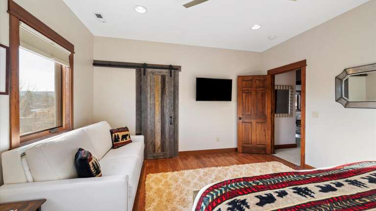 The bunk room features a king bed on the bottom bunk, twin XL bed on the top bunk, a queen sofa sleeper, desk area, walk-in closet, and a HDTV with streaming capabilities.