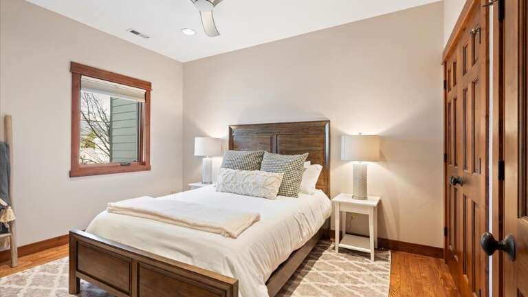 The guest room features a luxury queen bed, HDTV with streaming capabilities, and a large closet.