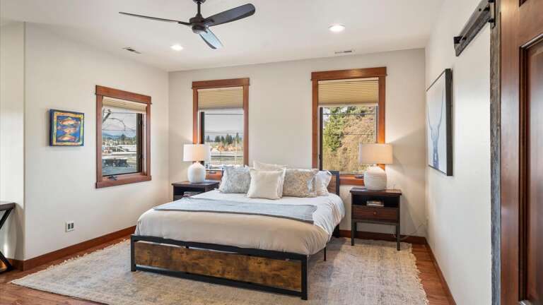 The master suite includes a luxury king bed, walk-in closet, desk area, ensuite bathroom, HDTV with streaming capabilities.