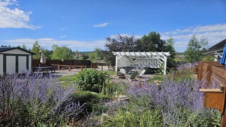 Step outside into the large private backyard area which features a brand new 6-person hot tub under a pergola wrapped in mood-setting string lights along with a gas grill and firepit seating area.