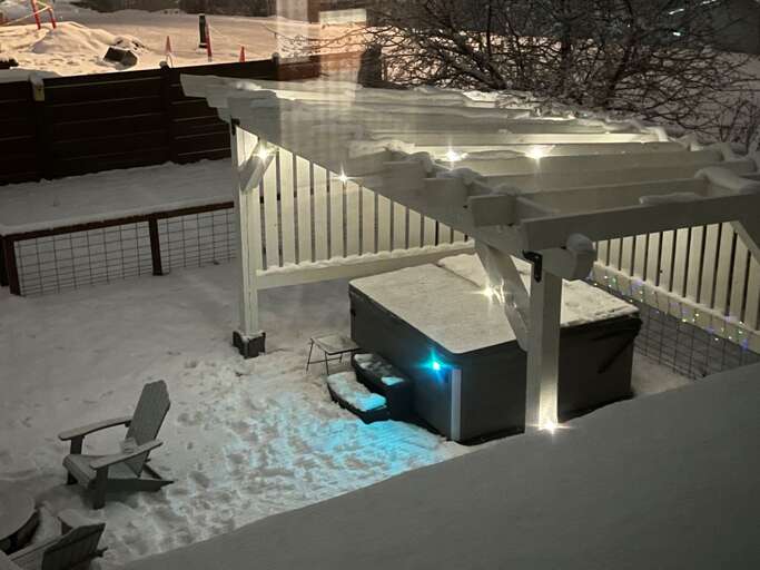 Step outside into the large private backyard area which features a brand new 6-person hot tub under a pergola wrapped in mood-setting string lights along with a gas grill and firepit seating area.